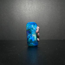 Purple Sea Horse Bead on an Ocean Themed Back Ground with Dichroic.
