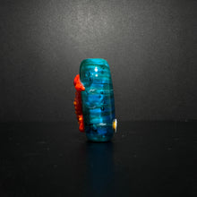 Red and Orange Sea Horse Bead on an Ocean Themed Back Ground.