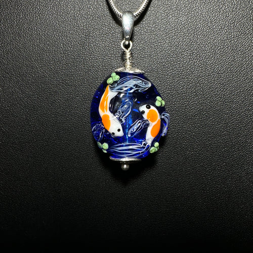 Koi Pond Pendant.  Two Koi Swimming Together on a Blue Background.