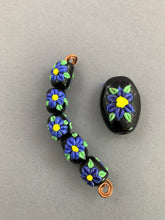 Periwinkle wild flower set.  Floral Beads.  Lampwork Beads. Purple blue flowers on black background.