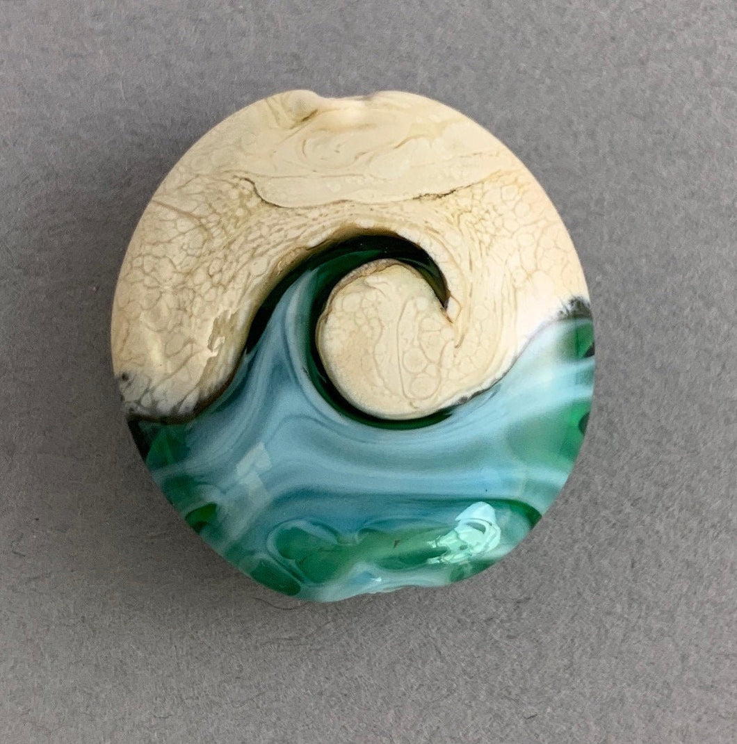 caribbean sea lampwork bead with a wave
