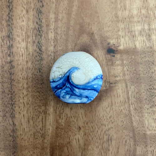 blue and sand colored glass wave bead
